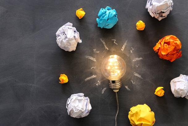 Education concept image. Creative idea and innovation. Light bulb as metaphor over blackboard - Foto, immagini