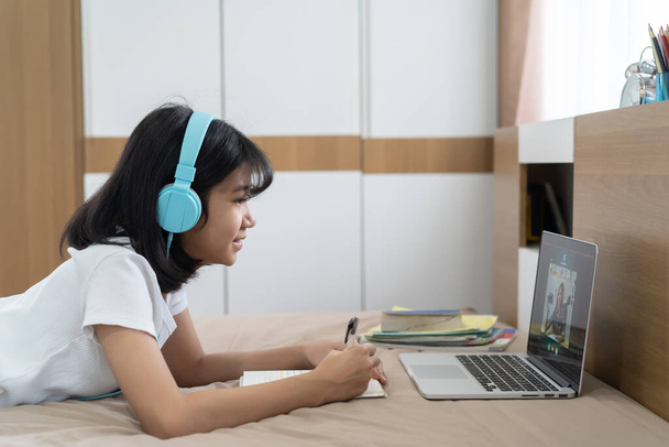 Asian girl studying homework online lesson at home, Social distance online education idea concept - Fotó, kép