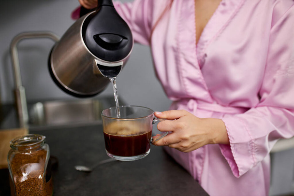 young beautiful woman making a cup of coffee - 写真・画像