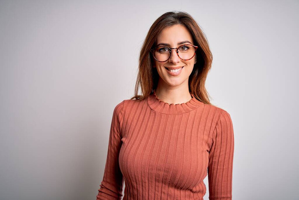 Young beautiful brunette woman wearing casual sweater and glasses over white background with a happy and cool smile on face. Lucky person. - Photo, Image