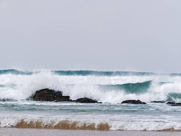 Hullámok ütköznek sziklák és partvonal felett helyet a fenti szöveges - Fotó, kép