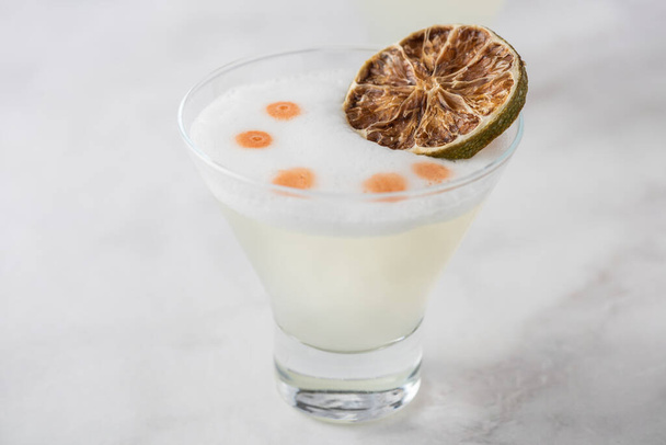Pisco Sour with dry lime and white foam - Photo, Image