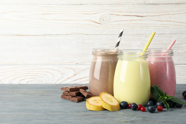 Delicious milkshakes on wooden background. Summer drink - Photo, image