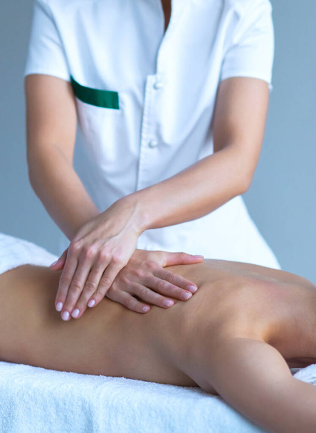 Gros plan sur les traitements traditionnels de guérison et de massages récréatifs. Une jeune femme au spa. Santé, soins de la peau, massage, ostéopathie et thérapie manuelle concept. - Photo, image
