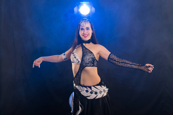 Spirituality dance. Beautiful sexy woman with luxury glossy eastern make-up dancing tribal fusion. Belly dance. - Foto, imagen