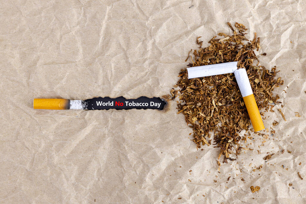 Cigarette burning the brown paper.Concept quit,stop smoking and world no tobacco day. - Photo, Image