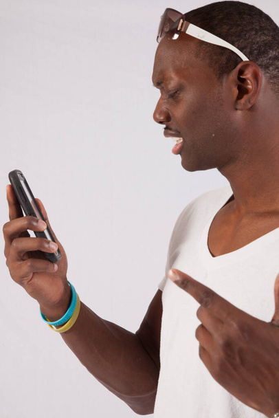 Pensive black man on a cell phone - Фото, изображение