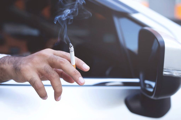 A man who smokes in the car - Фото, изображение
