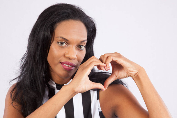 Pretty Black woman with her hands in a heart shape - Photo, Image