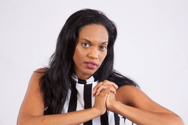 Lovely Black woman in stripped blouse with her hands folded - Foto, Bild
