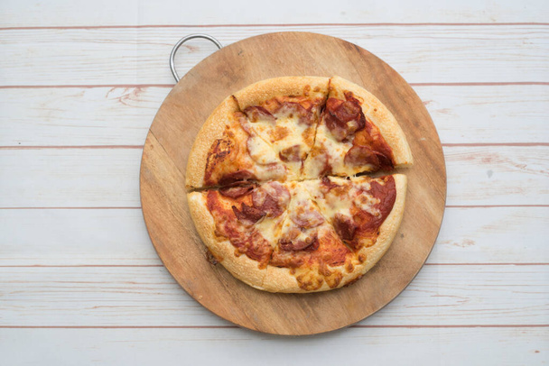 Pizza de pepperoni en la tabla de cortar de madera.Vista desde arriba
. - Foto, Imagen