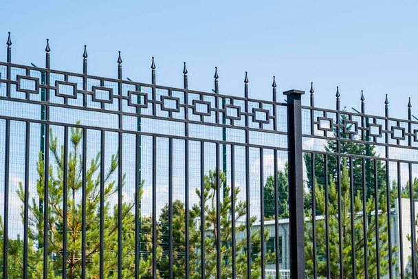 Steel grating fence made with wire on blue sky background. Sectional fencing installation. - Photo, Image