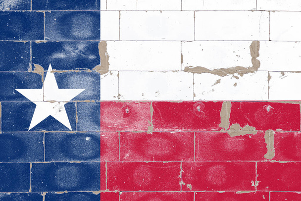 Flaga narodowa USA stanu Teksas jest niebieska w czerwieni i bieli z gwiazdą namalowaną na starej ceglanej ścianie z popękaną farbą w formie ulicznego graffiti w Dniu Niepodległości. - Zdjęcie, obraz