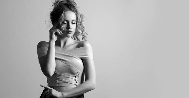 Black and white portrait of luxury young woman with curly hair and bare shoulders. Space for text - Photo, Image
