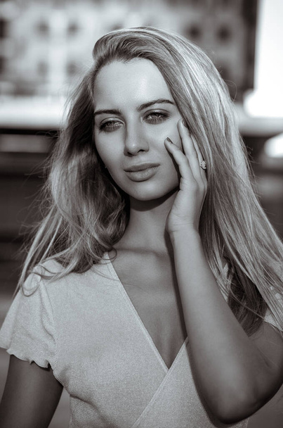 Closeup portrait of luxury model with perfect skin and long blonde hair. Black and white toning - Zdjęcie, obraz