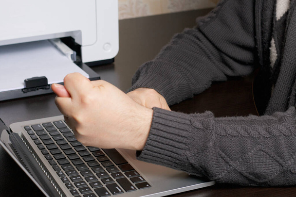 A man works at a laptop. Shows a combination of three fingers in the camera. Hands are taken close up. - Foto, immagini