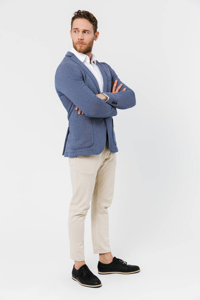 Image of serious young man wearing jacket posing and looking aside isolated over white background - Photo, image