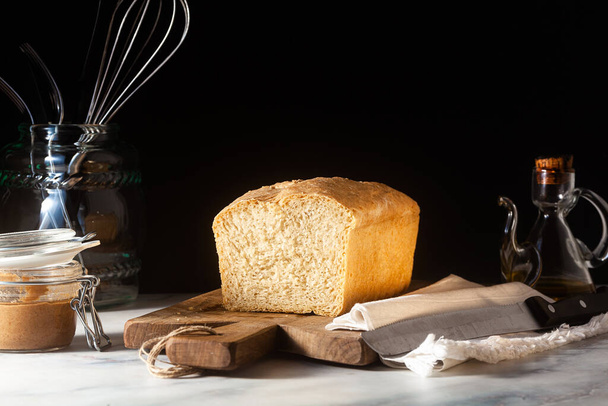 Fresh homemade Toast bread on the kitchen table, dark background. - 写真・画像