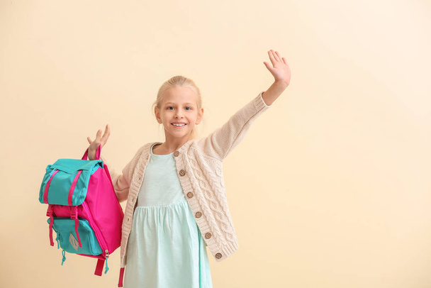 Cute little schoolgirl on color background - Photo, Image