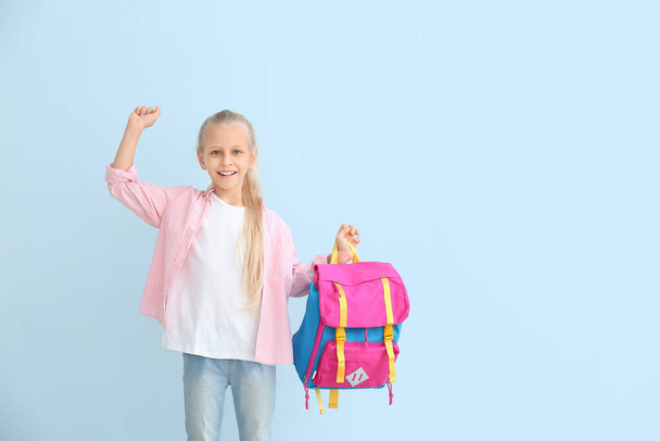 Cute little schoolgirl on color background - Foto, imagen