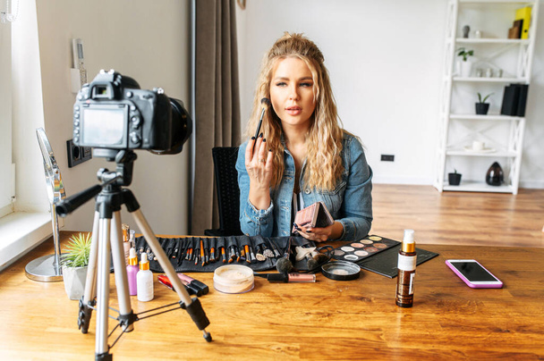 Blonde woman making a video for beauty blog - Foto, afbeelding