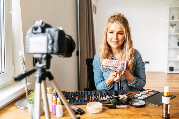 Blonde woman making a video for beauty blog - 写真・画像
