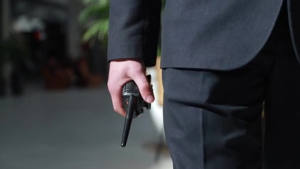The guard holds a walkie-talkie in his hand. Hand of a security guard holding an intercom in his hand. - Footage, Video