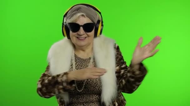 Elderly grandmother. Caucasian woman. Dance, celebrate, listen music. Chroma key - Footage, Video