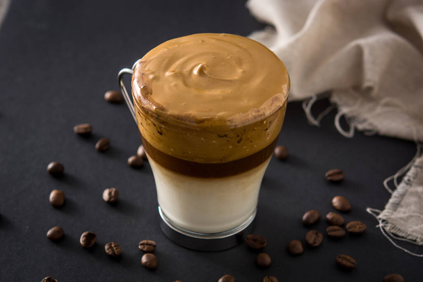 Creamy iced dalgona coffee on black background - Фото, изображение