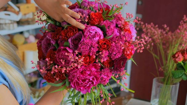 Professional florist making beautiful bouquet at flower store - Photo, Image