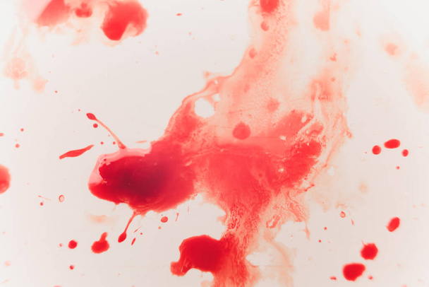 Fresh red blood splat on white porcelain with specks from the impact. Copy space area for horror themed concepts and ideas. macro - Photo, image