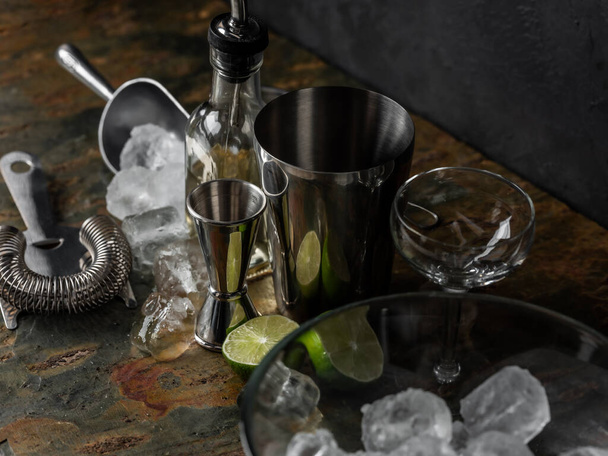 Cooking cocktail drinks by bartender hands with bar accessorize on black bar table stone background. - 写真・画像