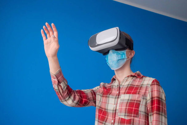 Jeune femme portant un masque médical et un casque de réalité virtuelle - concept VR - Photo, image