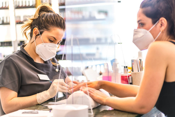 Manicure and pedicure salon with security measures in the reopening of the pandemic. Coronavirus - Фото, изображение