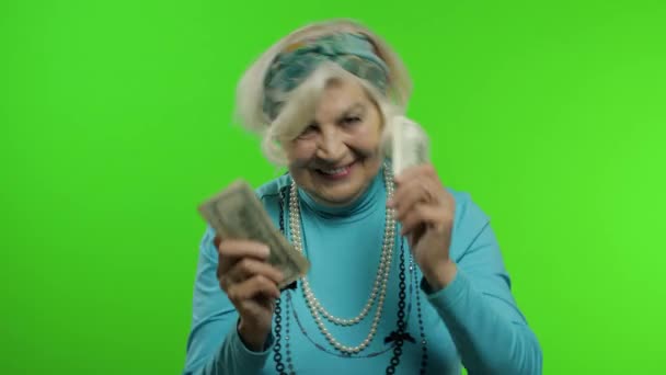 Elderly grandmother. Caucasian woman with money banknotes celebrates, smiling - Footage, Video