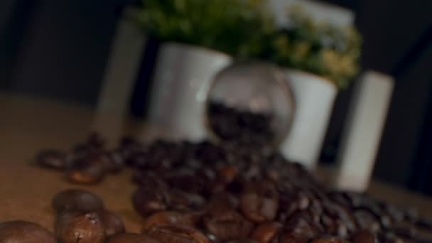 Roasted coffee beans background. Close-up of roasted coffee beans spinning slowly in a circle. Roasted coffee bean background, top view. - Materiał filmowy, wideo