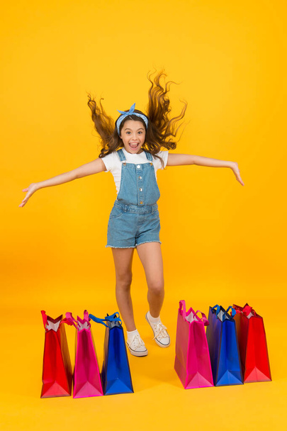 All for me. Little girl with shopping packages. Happy child with bags. Small child in summer style. Seasonal sales. Happiness of purchase. Shopping day. Fashion boutique. Cheerful girl shopping - Fotó, kép