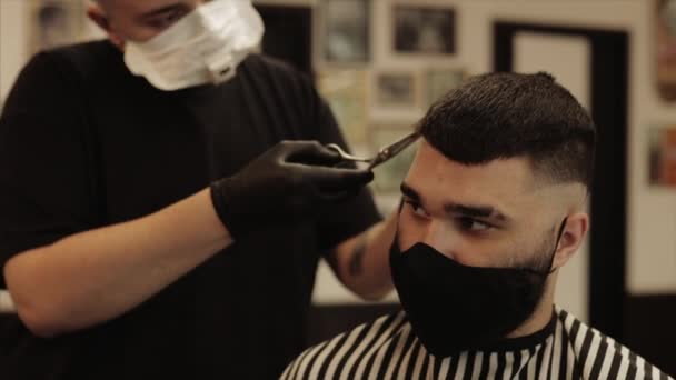 Mens haircut and hair styling in a barbershop, beauty salon.  - Кадри, відео