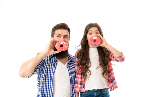 Dessert you can trust. Happy family eat fun donuts. Father and daughter enjoy dessert. Bearded man and child isolated on white. Dessert menu. Baked dessert. Bake shop. Bakery and cafe. - 写真・画像