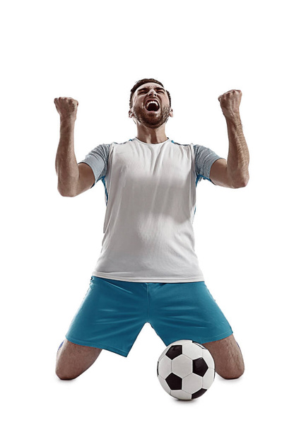 Young emotional football player on white background - Zdjęcie, obraz