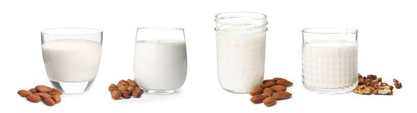 Set with different types of organic milk and nuts on white background. Banner design - Fotoğraf, Görsel