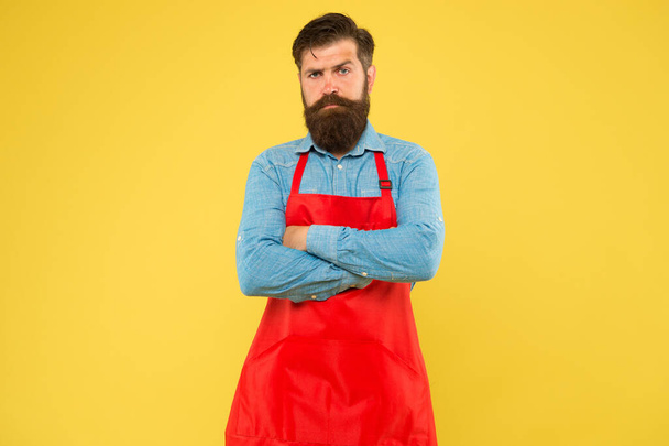 Restaurant cuisine. restaurant staff wanted. cooking is his hobby. bearded man in uniform. confident male housekeeper. Small business shop owner. mature shop assistant. professional chef in red apron - Foto, imagen