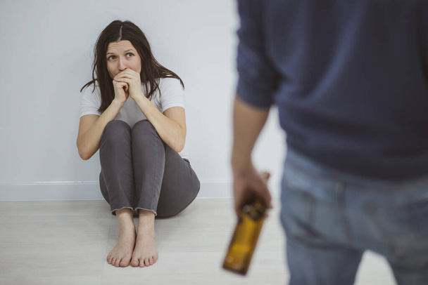 Domestic violence concept in a family argument with drunk alcoholic. - 写真・画像