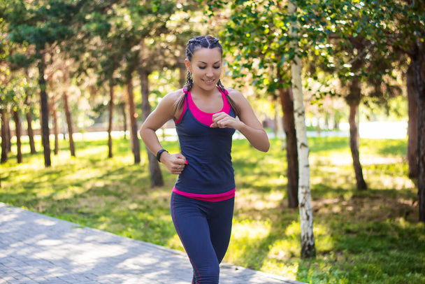 sporty woman doing jogging in the park - Photo, Image