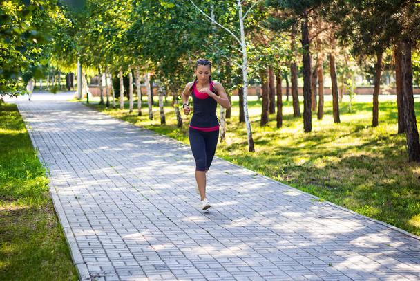 sporty woman doing jogging in the park - Fotó, kép