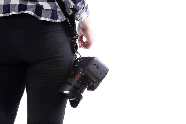 Close up view of unbranded lens and camera carried by a self-employed female gig photographer or art student.  The white background can be used for composites - 写真・画像