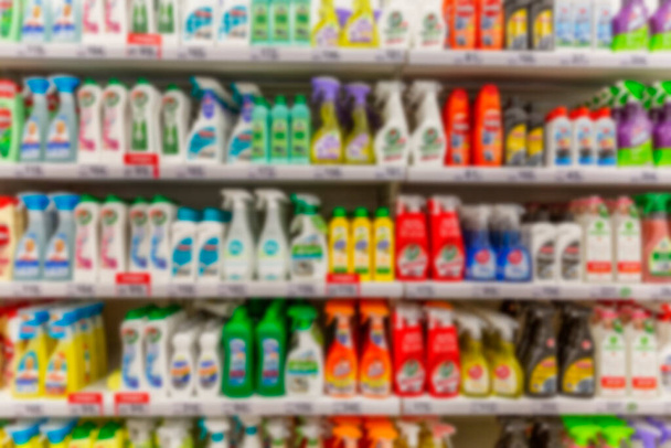 Large selection of cleaning products on the shelves in the supermarket. Blurred. Front view. - Photo, Image