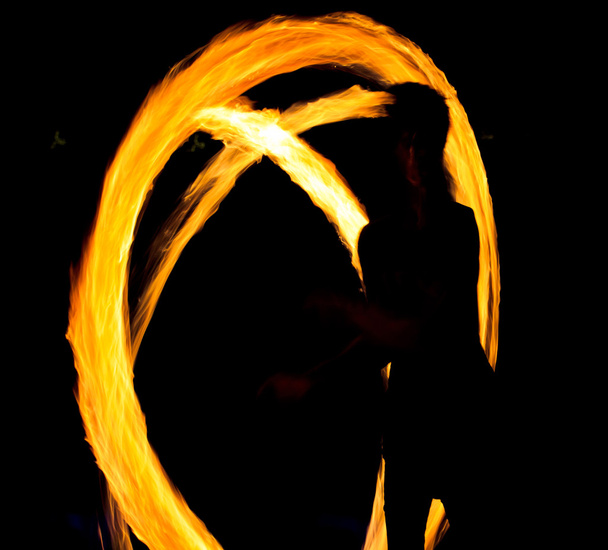 Night performance flaming trails - 写真・画像