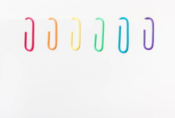 Paper clips of rainbow colors. LGBT flag. copyspace - Photo, Image