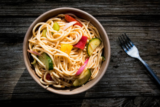 Spaghetti Salad on a wood table at an outdoor picnic - Photo, Image